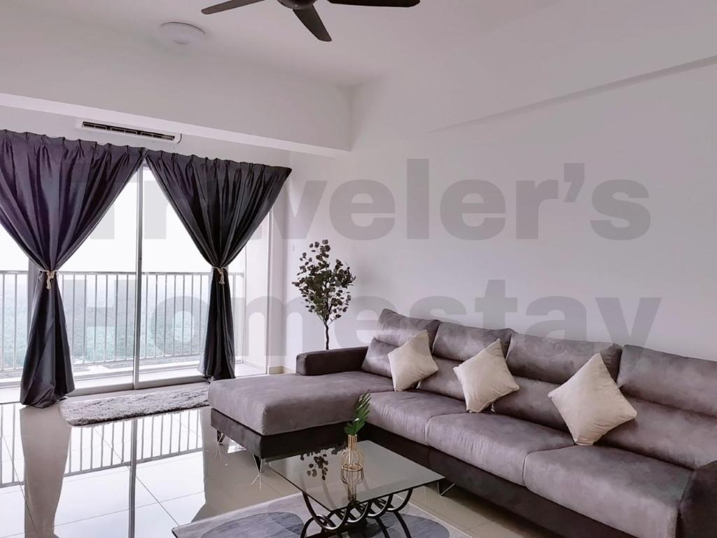 a living room with a couch and a large window at [FREE WI-FI]Travelers Homestay Sitiawan[6~10Pax]The Venus Apartment in Sitiawan