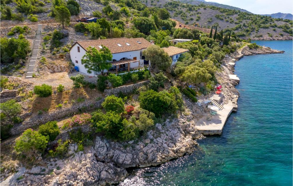 a house on a rocky island in the water at 4 Bedroom Stunning Home In Jablanac in Jablanac