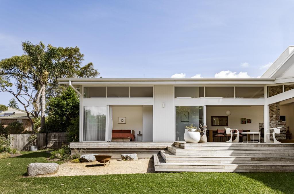 a house with a porch and a patio at The Loft @ Mollymook 70s Beach House in Mollymook