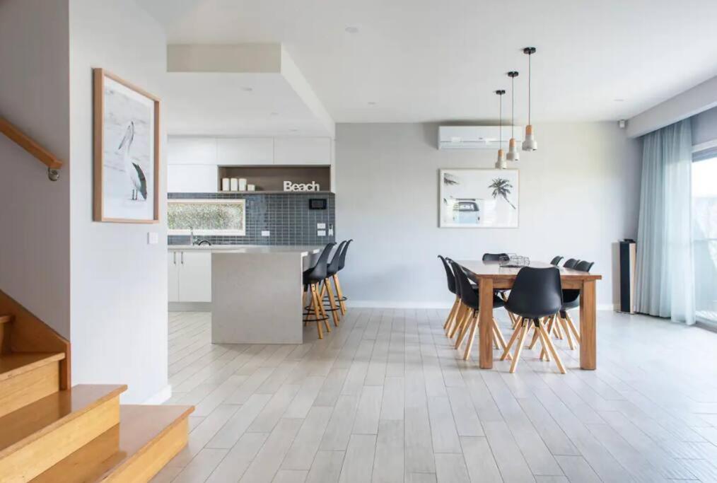 a kitchen and dining room with a table and chairs at Family Tides Beach House in Rosebud