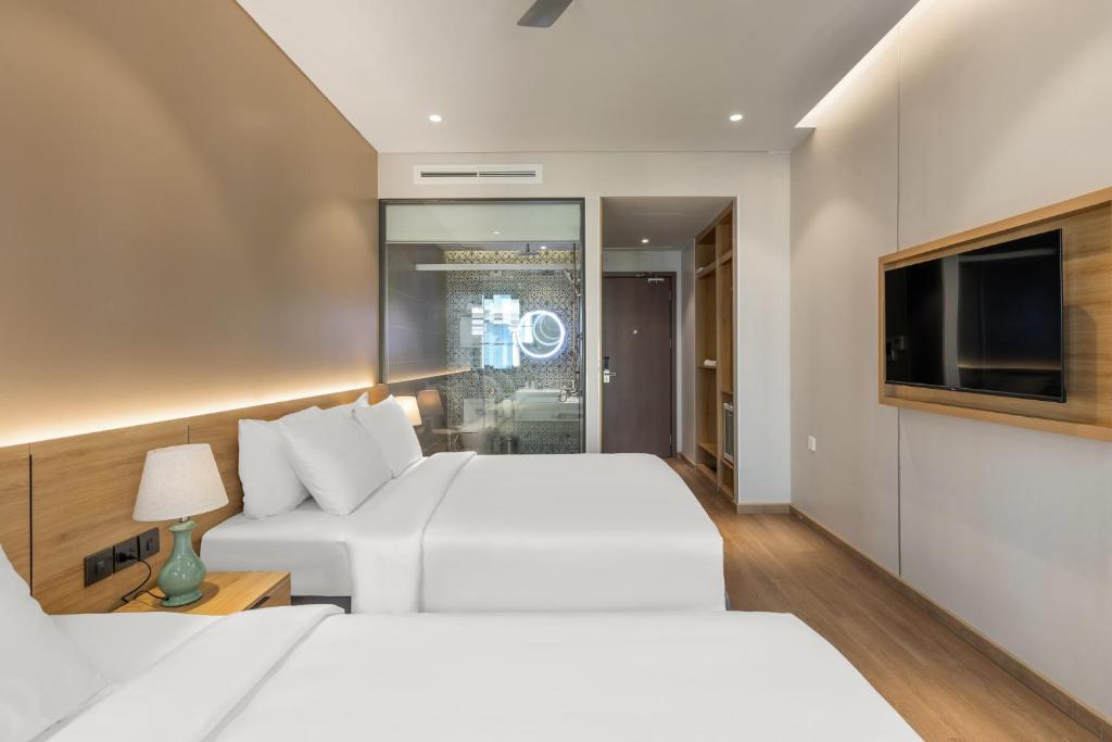 Postel nebo postele na pokoji v ubytování Laputa Hotel Phu Quoc