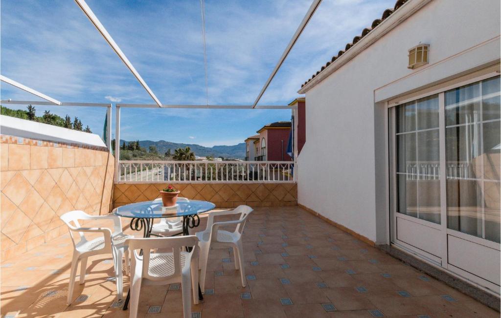 a patio with a table and chairs on a balcony at Gorgeous Apartment In Puente De Genave With Sauna in Puente de Génave