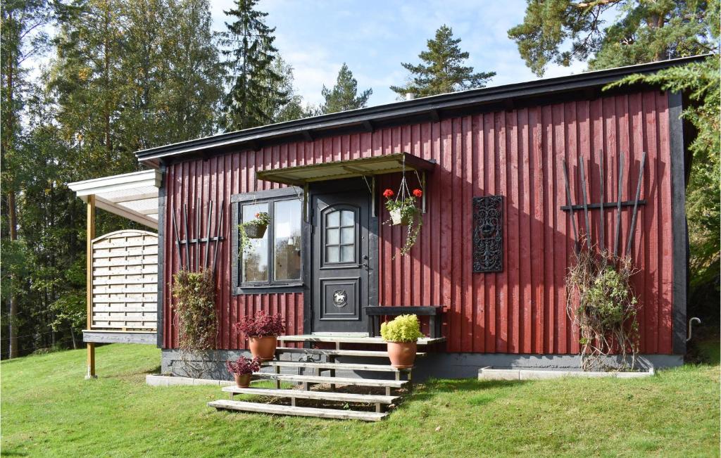a red house with stairs in front of it at Beautiful Home In Finspng With Wifi in Finspång