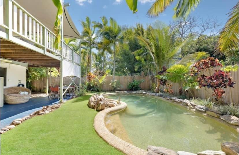a backyard with a hot tub in a yard at Villa Marshall in Machans Beach