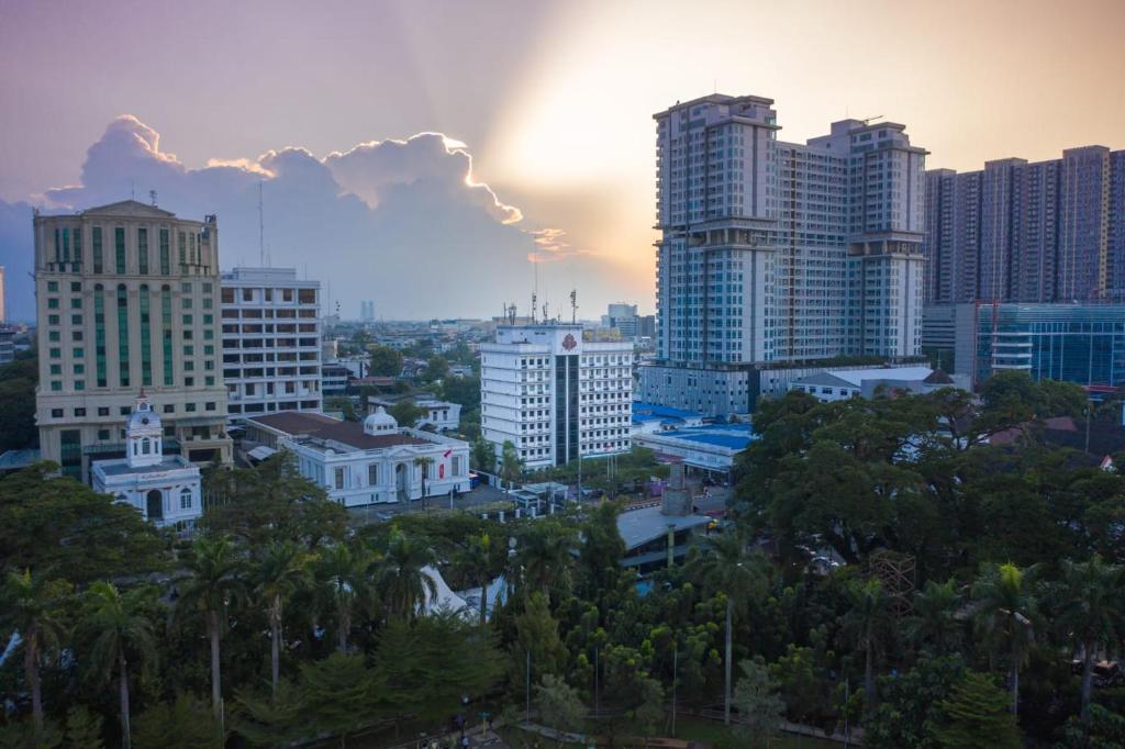 a city skyline with tall buildings and trees at Grand Inna Medan in Medan