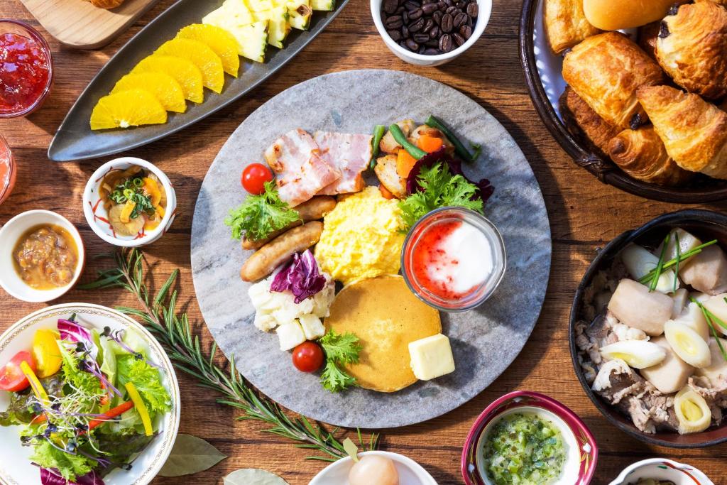 a wooden table with plates of food on it at Yamagata Grand Hotel in Yamagata