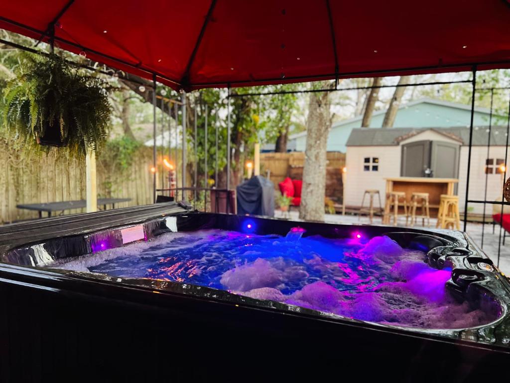 a hot tub on a patio with purple lights at Tropical Casita in Tampa near airport and Raymond James stadium in Tampa