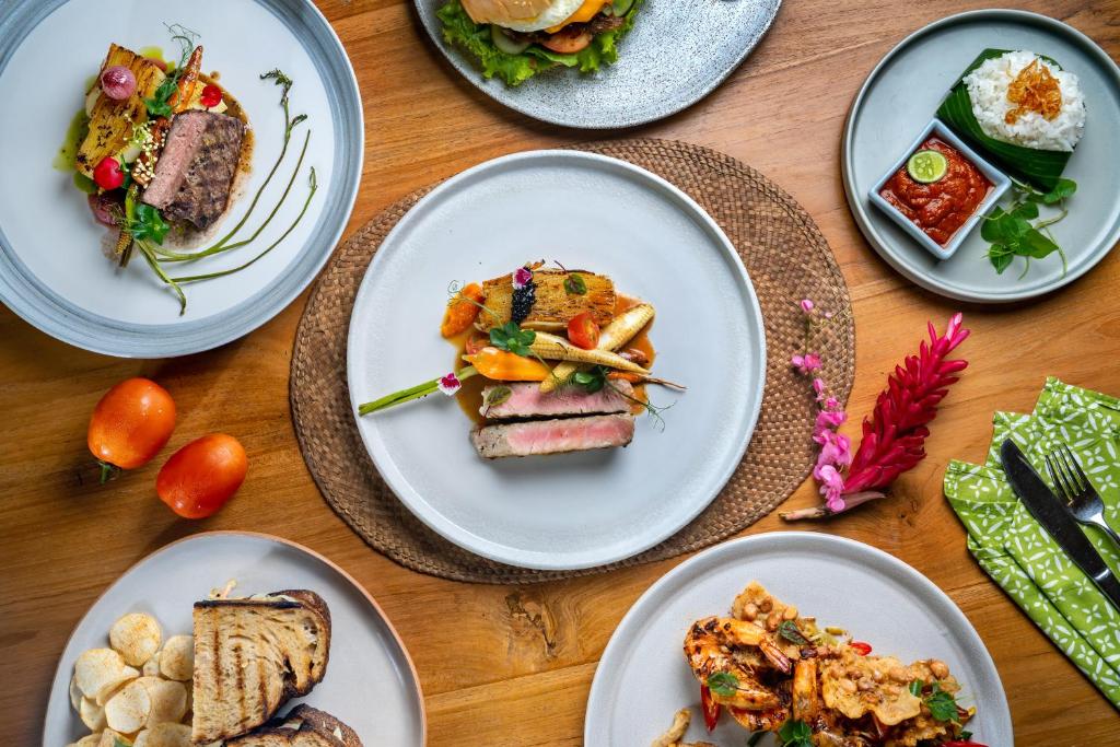 a group of plates of food on a table at Jati Cottage in Ubud