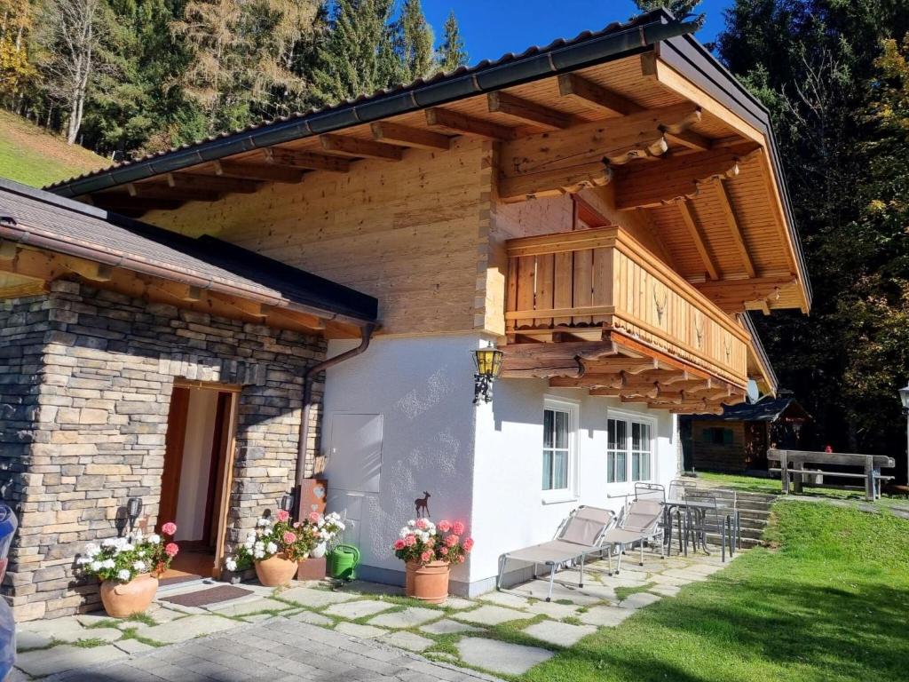 a house with a wooden balcony on top of it at Holiday house, Flachau in Flachau