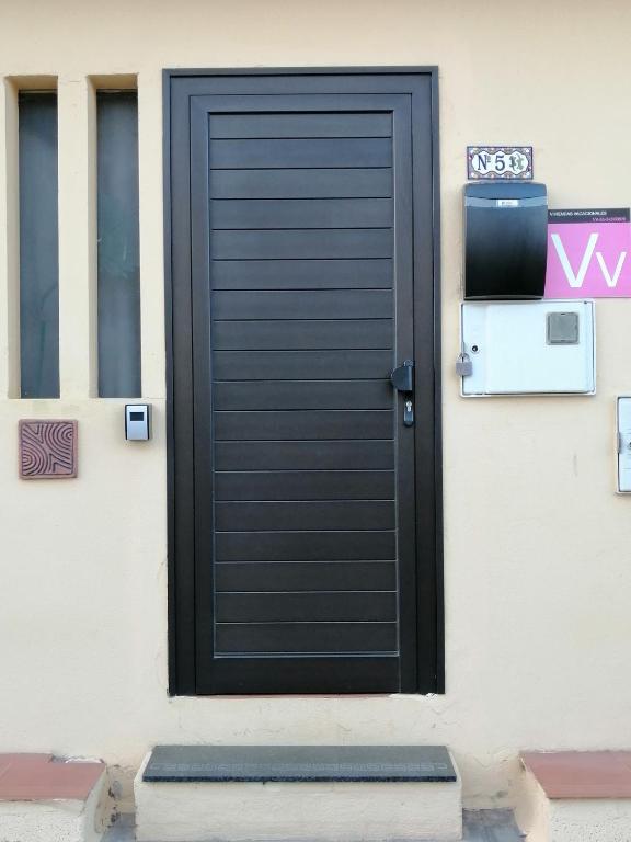 a black door on the side of a building at Casa Amaia in Arrecife
