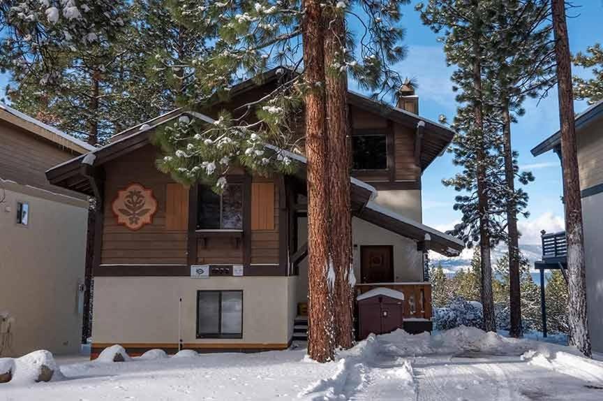 a house in the winter with snow in front of it at 1228 Timber Lane home in South Lake Tahoe
