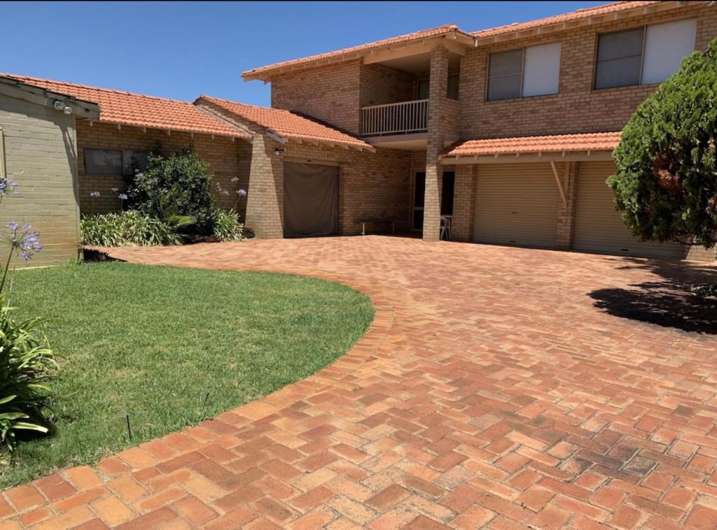 a brick driveway in front of a house at Ocean Vista Beach Stay in Rockingham