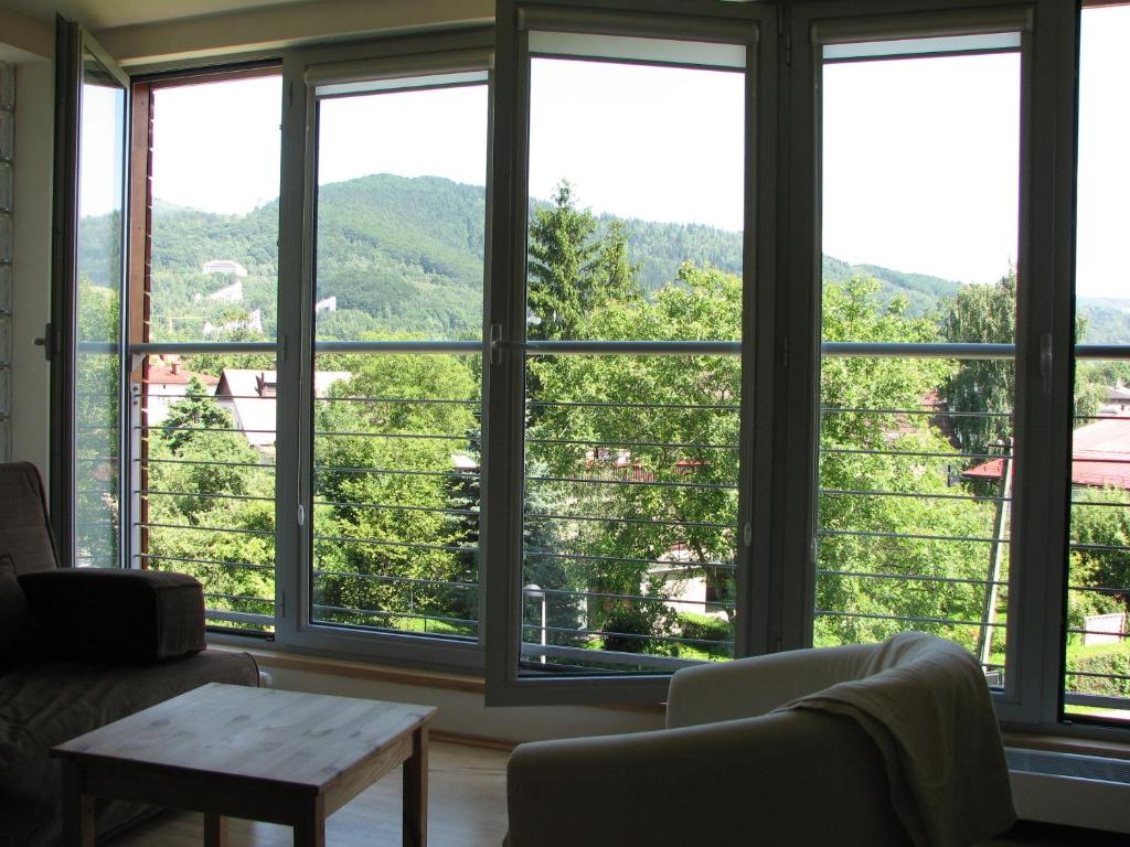 a living room with a large window with a view at Apartament w Ustroniu in Ustroń