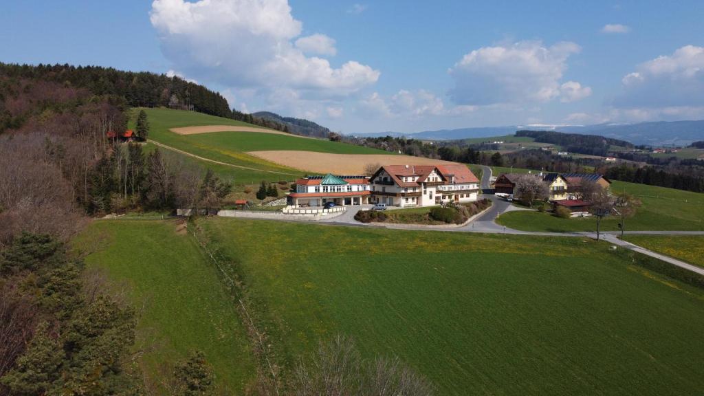 an aerial view of a house in a green field at Wohlfühl Hotel Wiesenhof in Grafendorf bei Hartberg