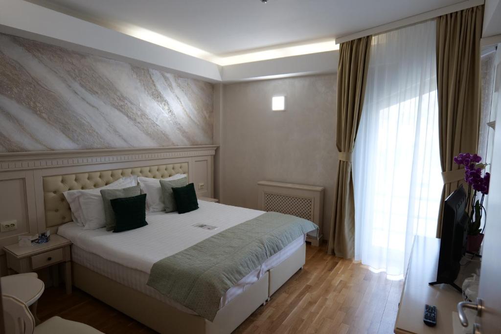 Rúm í herbergi á Park Luxury Rooms