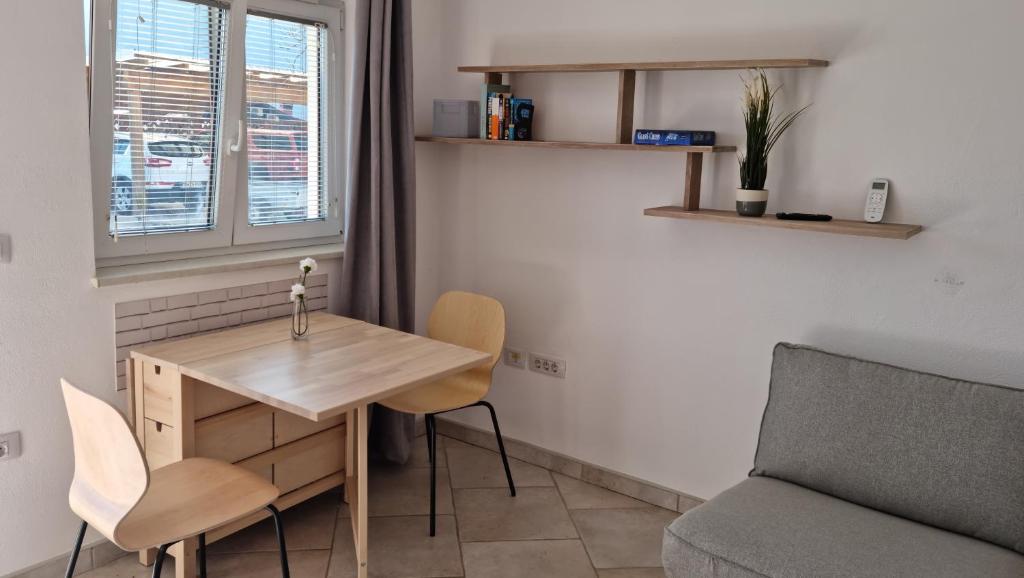 a small room with a wooden table and a chair at Nortra apartment in Tolmin