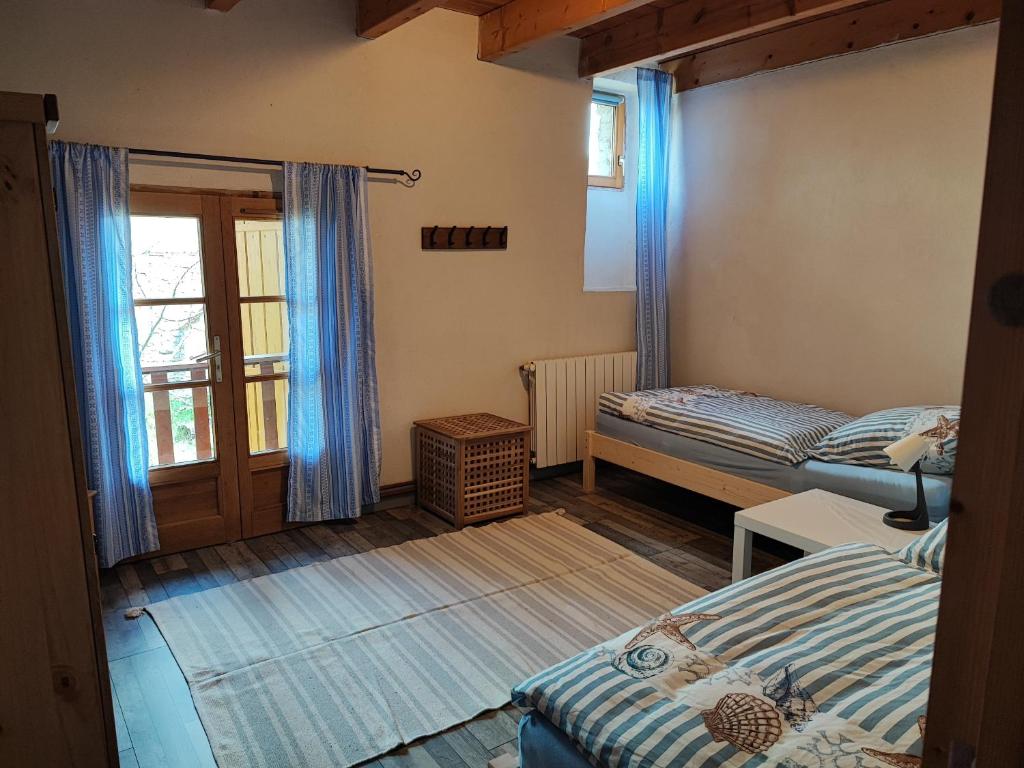 a small room with two beds and a window at Apartment Le 1739 in La Coste