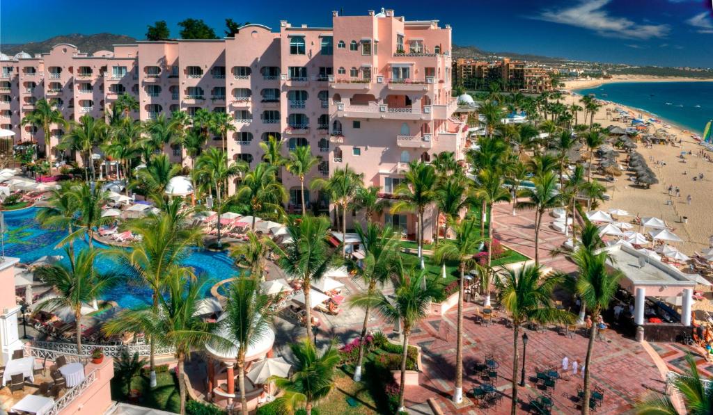 a beach with palm trees and palm trees at Pueblo Bonito Rose Resort & Spa - All Inclusive in Cabo San Lucas