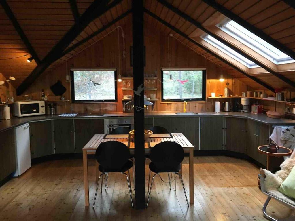 a kitchen with a table and chairs in a room at Enjoy The Nature And Quiteness Of Anholt in Anholt