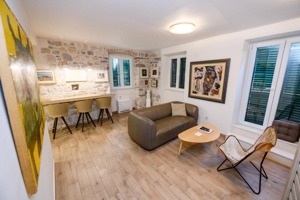 a living room with a couch and a table at Apartmani Art Karampana in Kotor