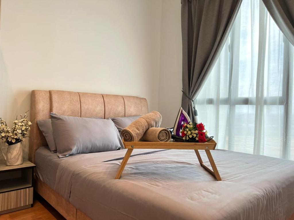 a bed with a table on top of it with a window at The Platino By Antlerzone in Johor Bahru