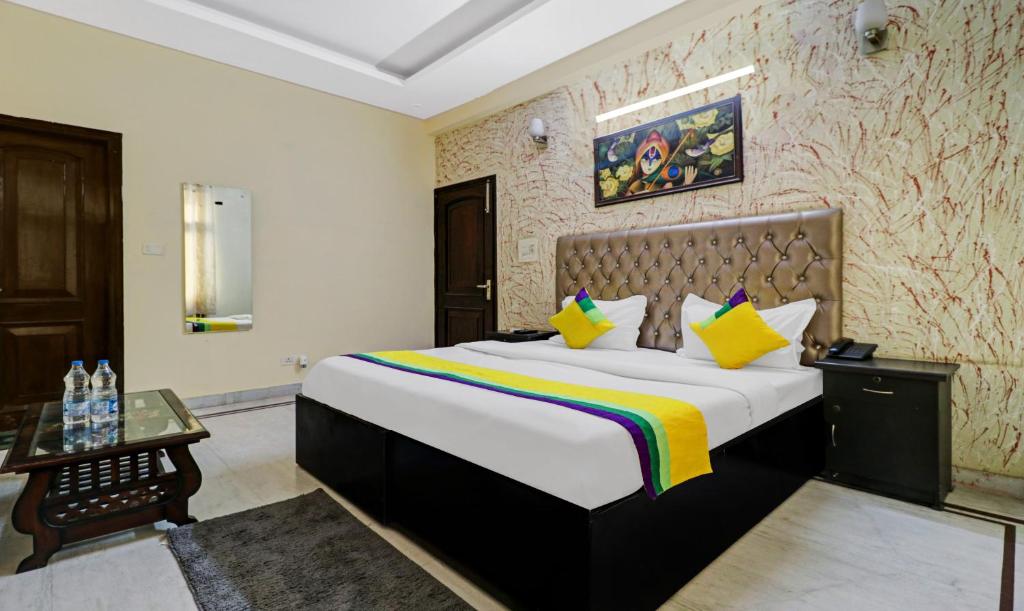 a bedroom with a large bed in a room at Hotel Sunrise,Noida in Noida