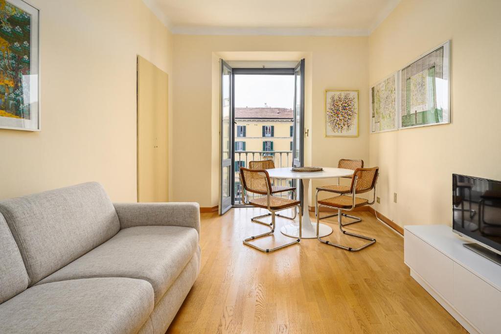 a living room with a couch and a table at Brera - San Marco Cozy Apartment in Milan