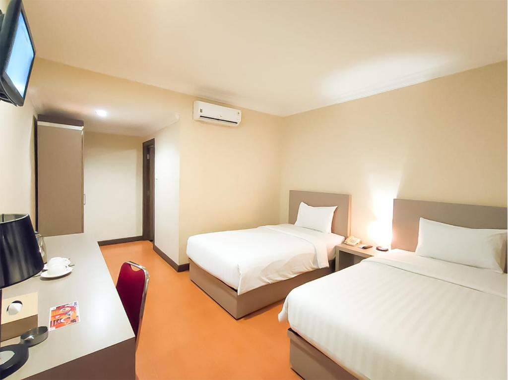 Postel nebo postele na pokoji v ubytování KAWANA HOTEL