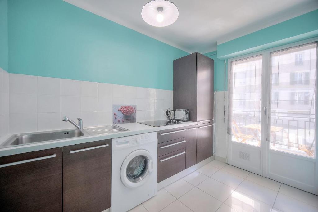 a kitchen with a sink and a washing machine at IMMOGROOM - Renovated apartment - Terrace - AC in Cannes