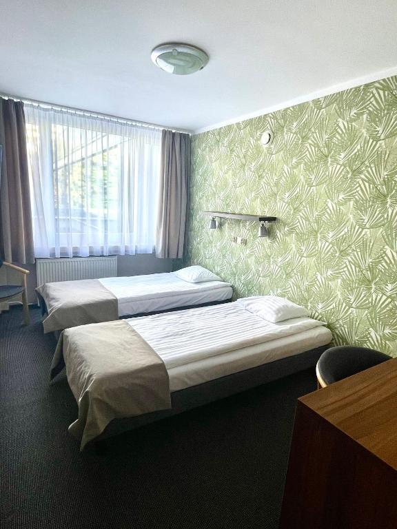 Posteľ alebo postele v izbe v ubytovaní Hotel Mazowiecki Łódź