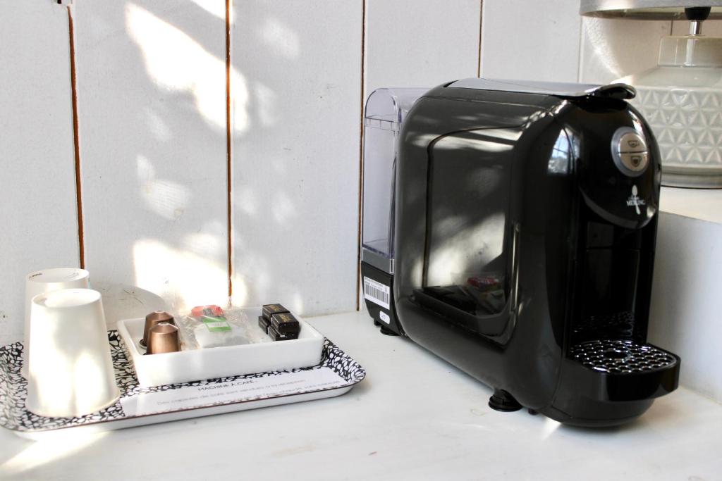 a toaster oven sitting on a counter next to a candle at Fleur de Ré in Loix