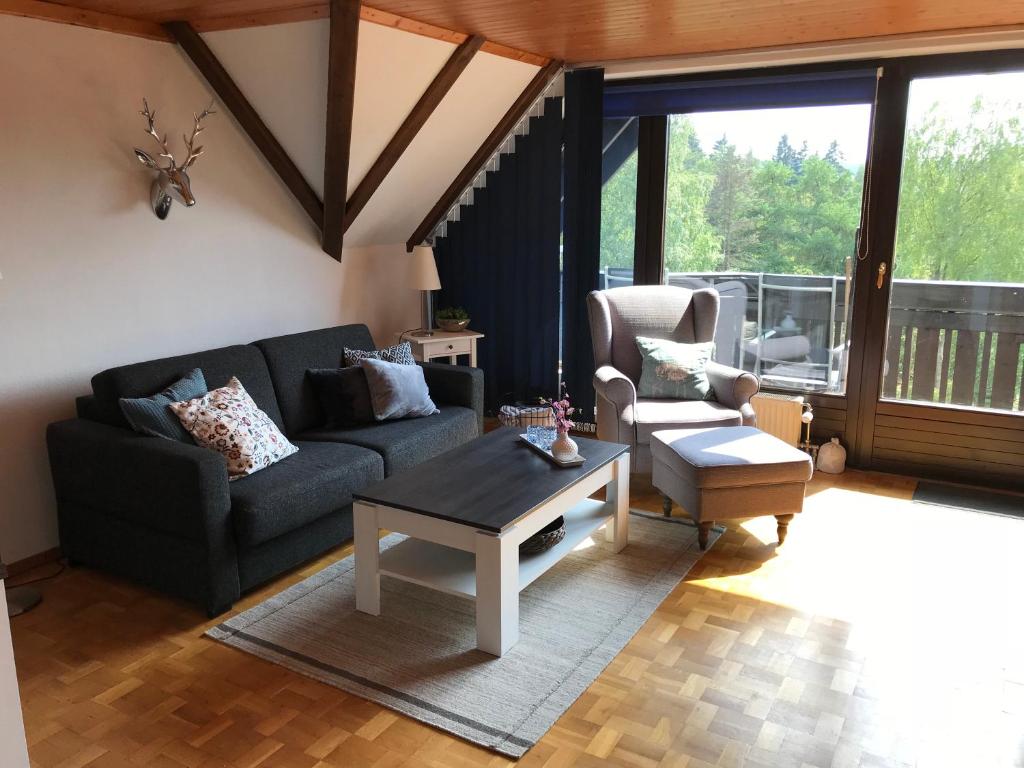 een woonkamer met een bank en een salontafel bij Ferienwohnung Weitblick am Kurpark in Braunlage