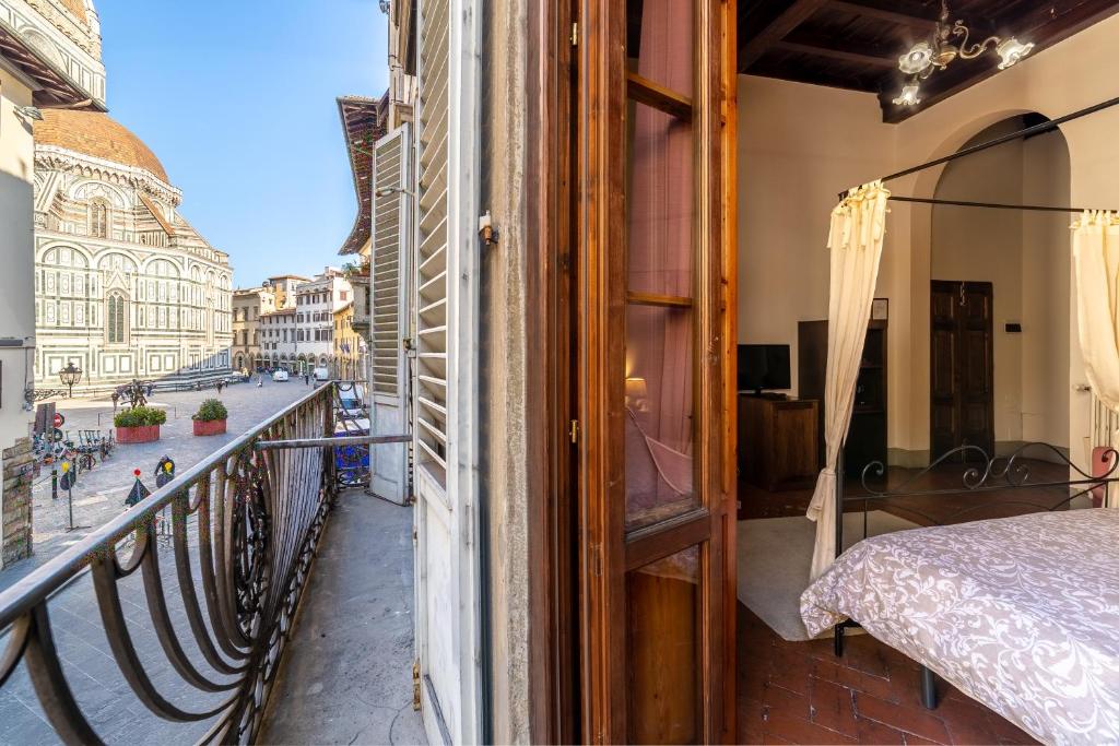 a balcony with a bed and a view of a city at La Residenza del Proconsolo in Florence
