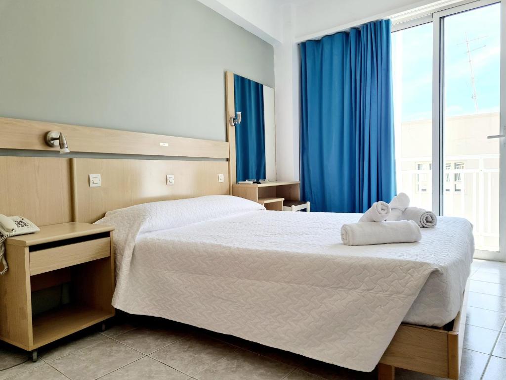 a hotel room with a bed with towels on it at G92 City Hotel in Rhodes Town