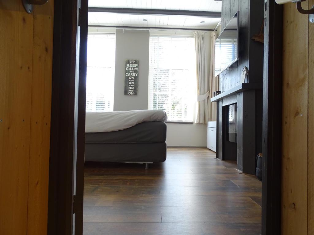 a bedroom with a bed and a fireplace in a room at B&B Tulden Farmhouse in Giethoorn