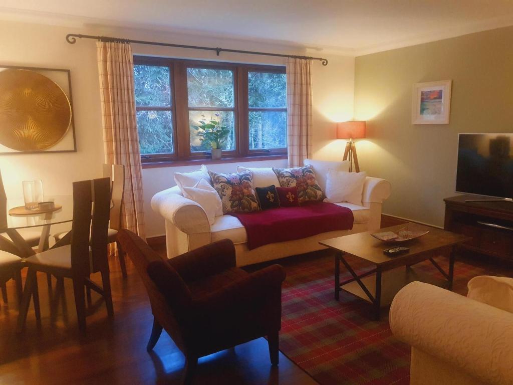 a living room with a couch and a table at Apartment at Drummond Crescent in Inverness