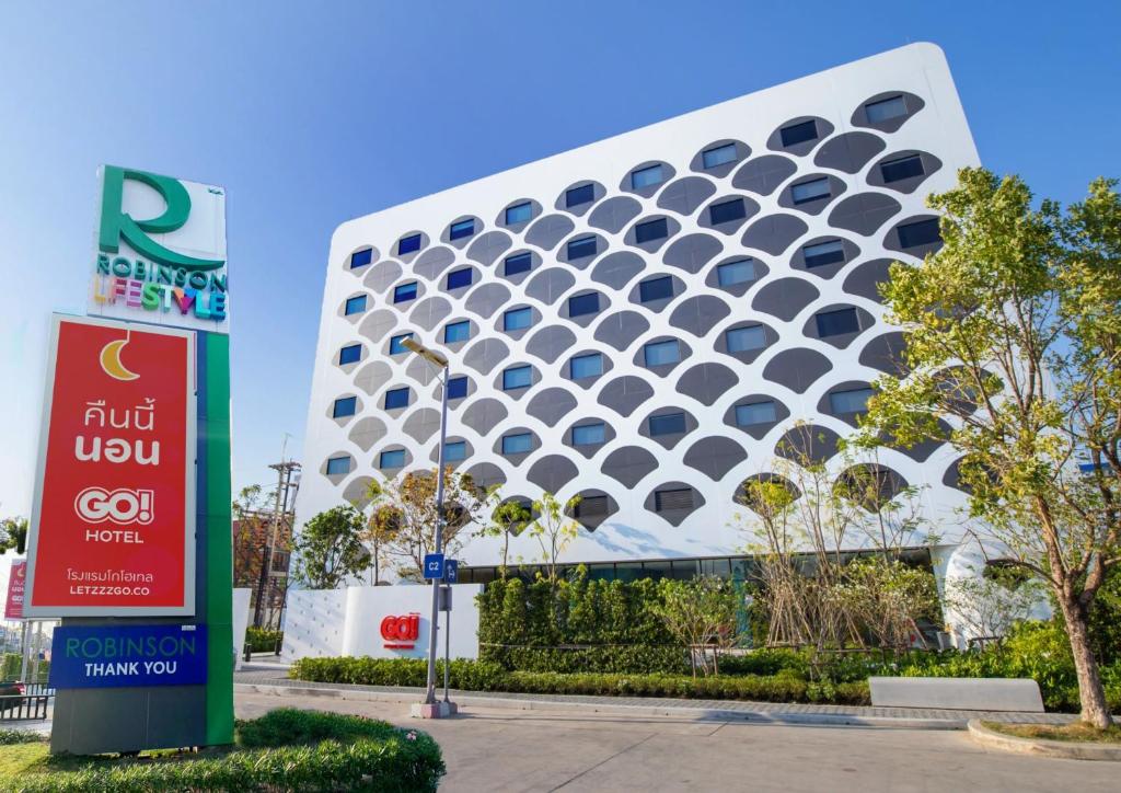 a building with a sign in front of it at GO Hotel Bowin at Robinson Lifestyle Bowin in Si Racha