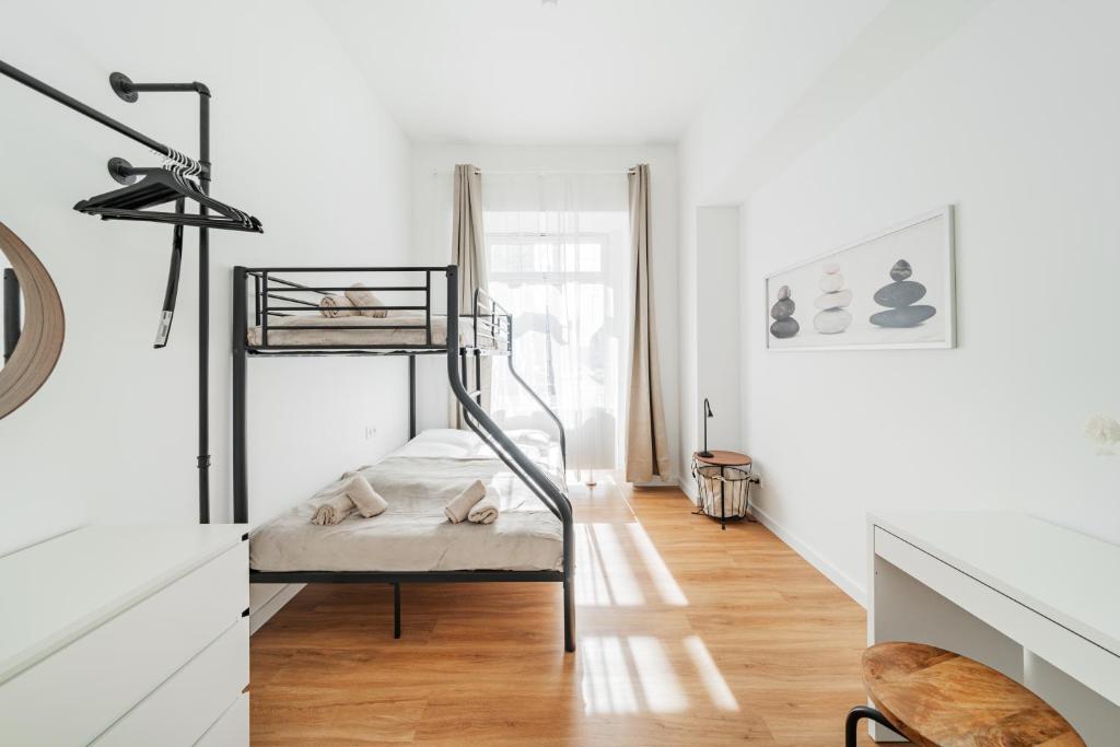 a white room with a bunk bed in it at Modern Central City Rooms in Vienna
