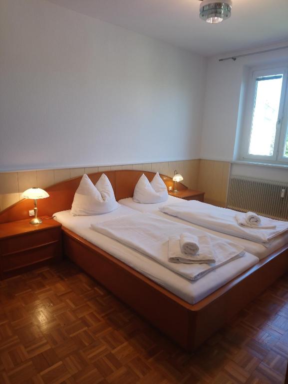 a large bed with white sheets in a room at Melker Apartment in Melk