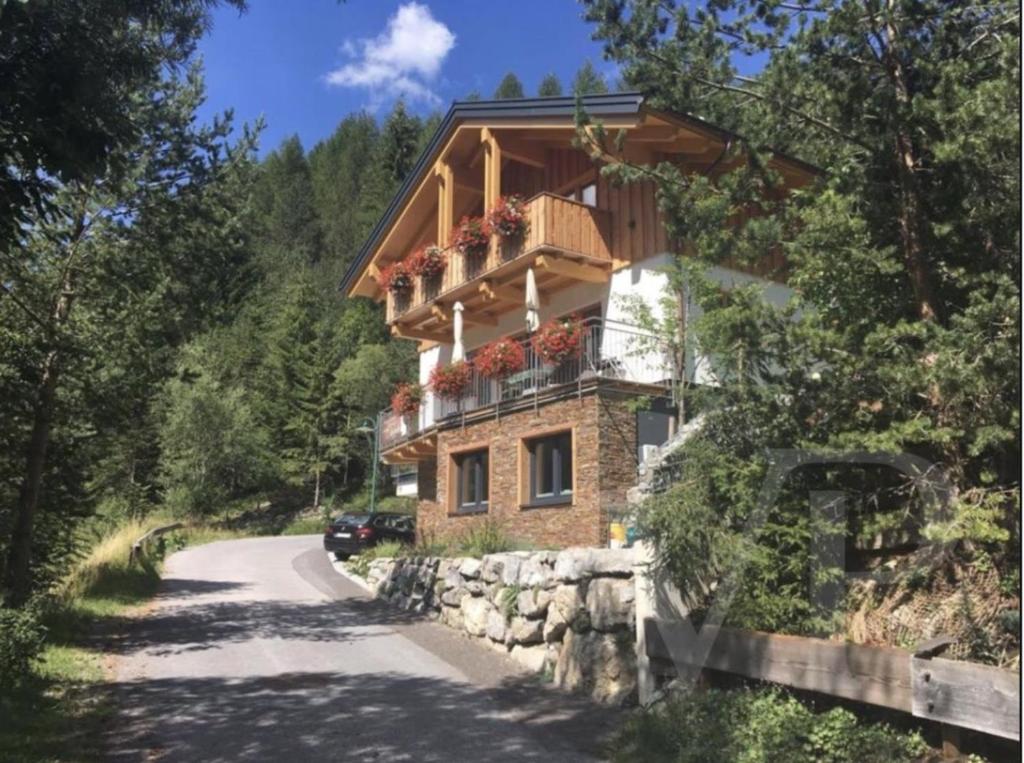 a house with a balcony on the side of a road at Ferienchalet Elisabeth in Steeg