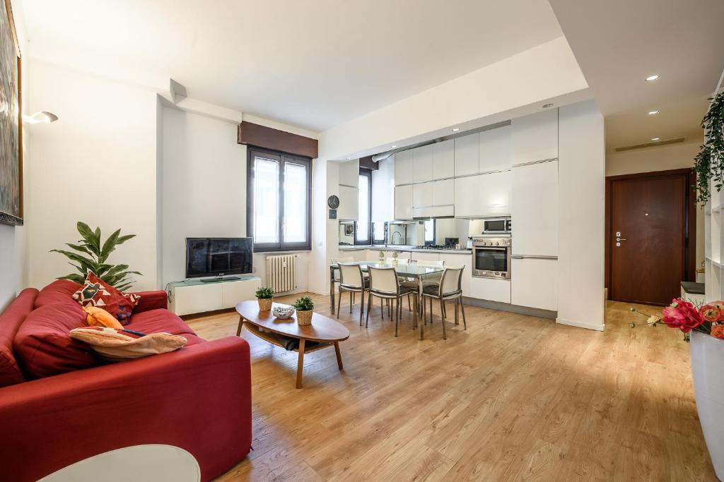 a living room with a red couch and a table at tHE Lantern Flat in Milan