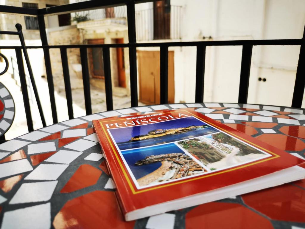 a book sitting on a table on a balcony at Vida y Mar Apartamentos in Peñíscola