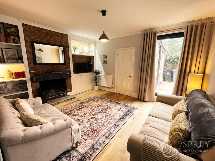 a living room with a couch and a fireplace at Sunnybank - Traditional 3 bedroom cottage in Lincolnshire