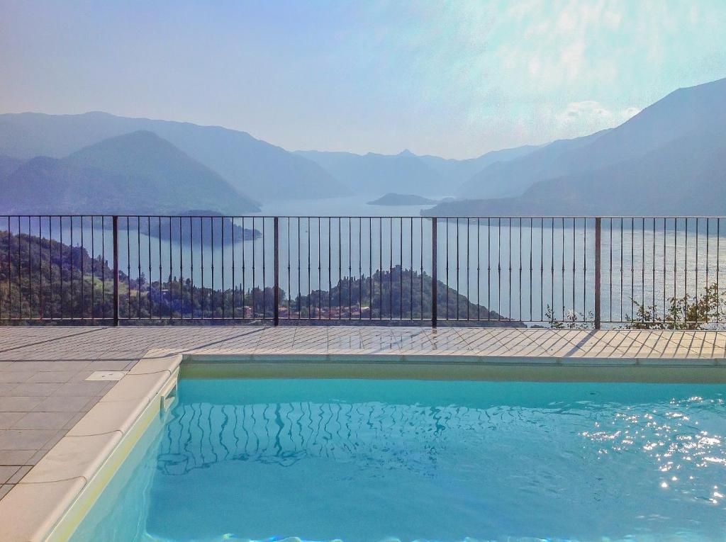 a swimming pool with a view of mountains at Varenna Wanderlust in Perledo
