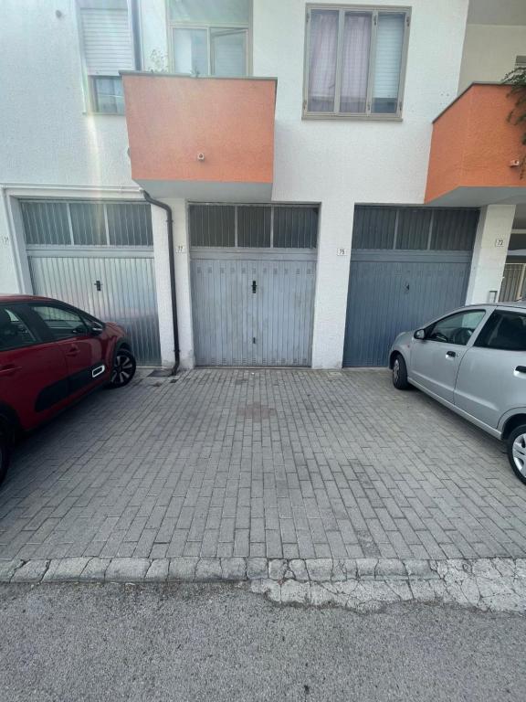 two cars parked in a parking lot in front of a building at Appartamento “Don King” in Ortona