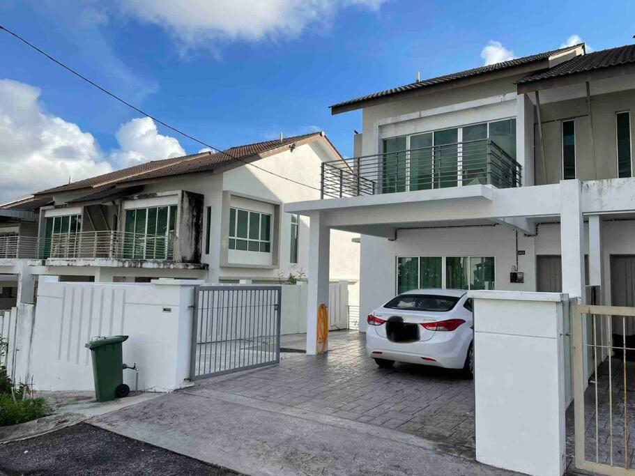 a white car parked in front of a house at Homestay Balik Pulau 2.0 3BedRoom in Balik Pulau