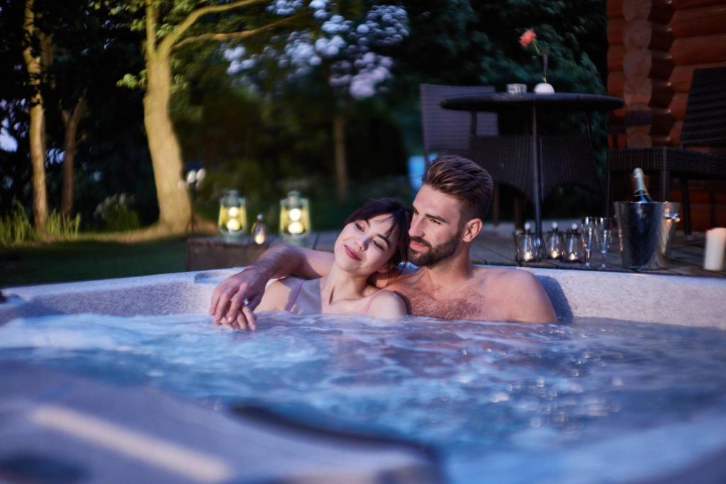 a man and a woman in a hot tub at Faweather Grange in Bingley