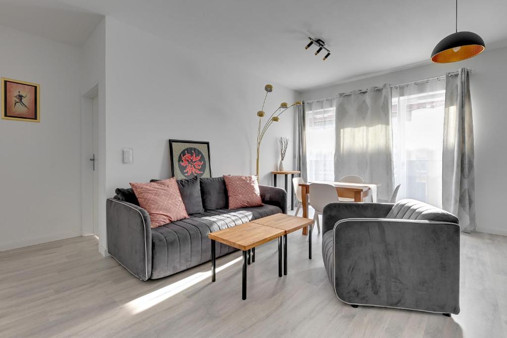 a living room with a couch and a table at Comfort Apartments Rajska in Gdańsk