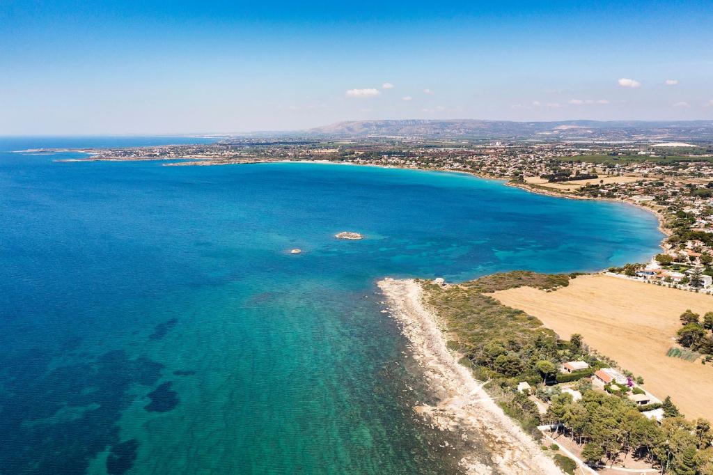 an aerial view of a beach and the ocean at Marinella in Terrauzza