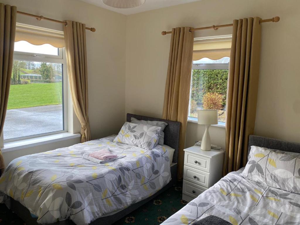 a bedroom with two beds and a window at ChestNut View Oldcastle 1 bed-room self catering in Oldcastle